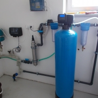 Water treatment plant in a family house – from left: pressure vessel, control unit, UV lamp, tube filters, fiberglass automatic filter.