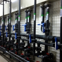 Plastic piping leading to plastic open filters in operation.